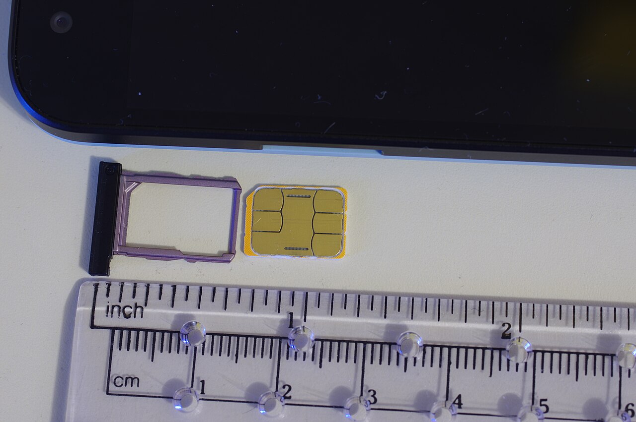 A nano SIM card and tray, the format used in modern smartphones